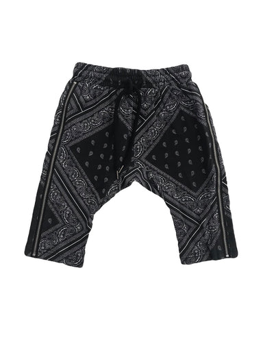 A pair of kids black and white shorts featuring zips down each side